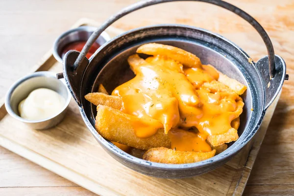 French fries with cheese on top — Stock Photo, Image