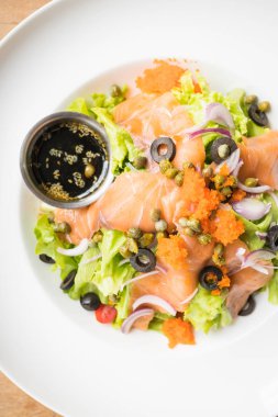 Beyaz tabak içinde somon salata