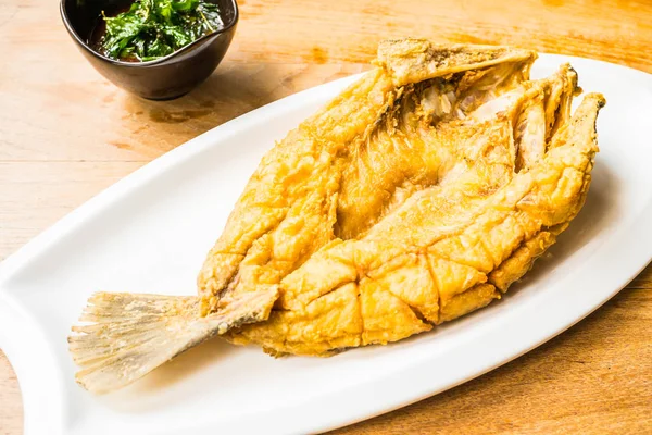 Fried sea bass fish in white plate with spicy and sweet sauce — Stock Photo, Image