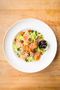 Beyaz tabak içinde somon salata