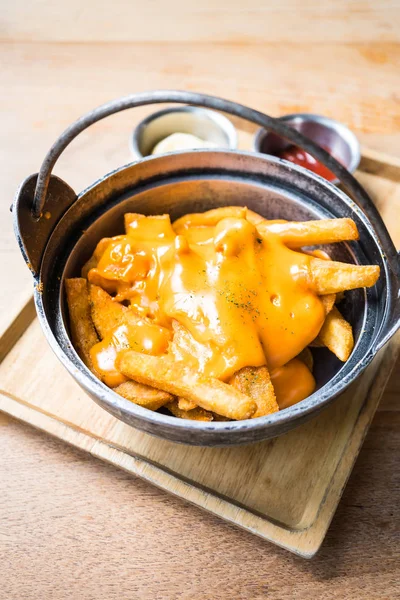 French fries with cheese on top — Stock Photo, Image