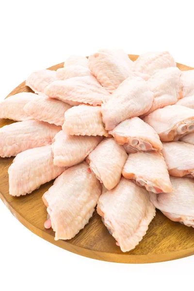 Raw chicken meat and wing on wooden cutting board or plate — Stock Photo, Image