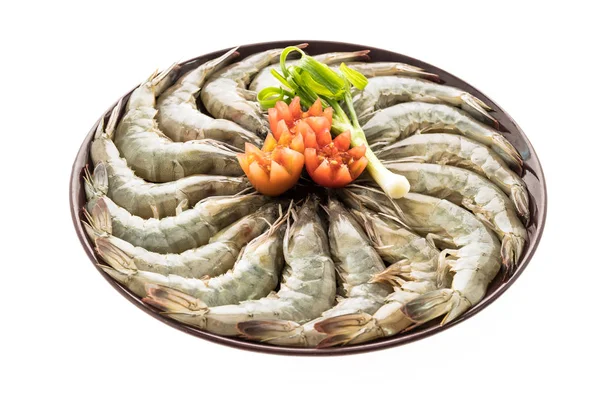 Crevettes crues et crevettes en assiette — Photo