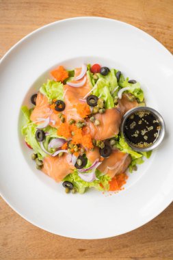 Beyaz tabak içinde somon salata