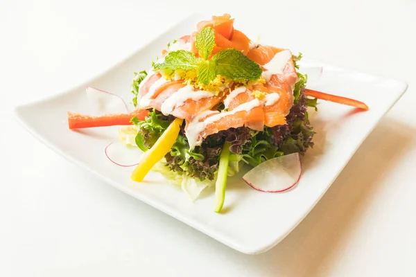 Salmon salad in white plate — Stock Photo, Image