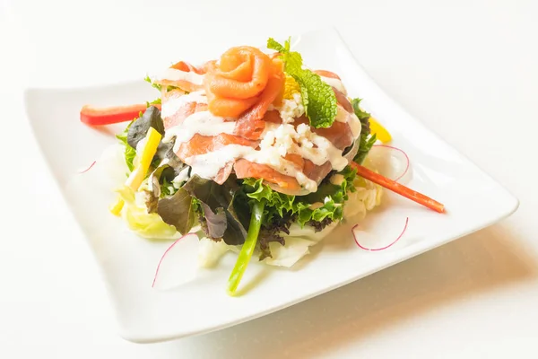 Salmon salad in white plate — Stock Photo, Image