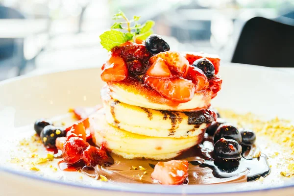 Pancakes with mixed berry fruit in white plate — Stock Photo, Image