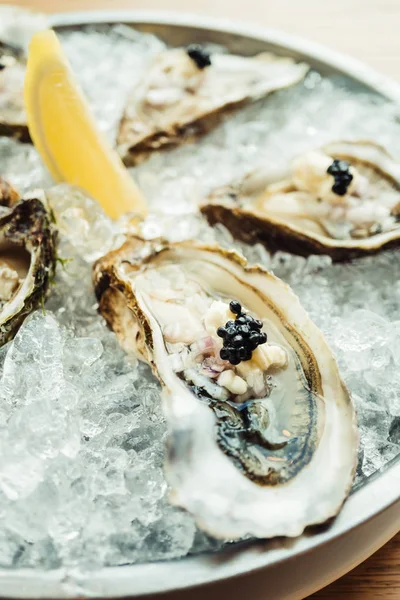 Ham ve taze istiridye havyar üstte ve limon ile