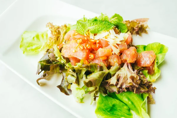 Raw tuna meat salad with spicy sauce — Stock Photo, Image