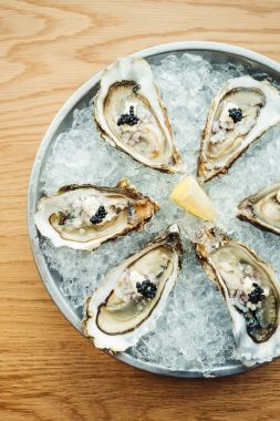 Ham ve taze istiridye havyar üstte ve limon ile