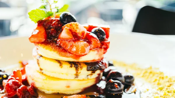 Pannenkoeken met gemengde bessen fruit in witte plaat — Stockfoto