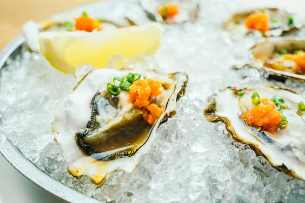 Raw and fresh Oyster with caviar on top and lemon — Stock Photo, Image