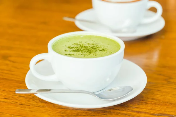 Hot green matcha latte in white cup — Stock Photo, Image