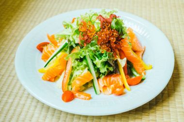 Beyaz tabak içinde somon salata