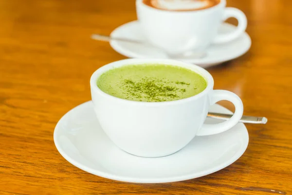 Hot green matcha latte in white cup — Stock Photo, Image