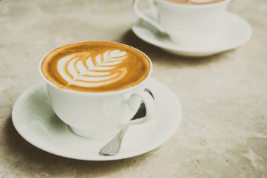 Beyaz fincan sütlü kahve ve kek ile