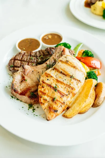 Chicken breast and Pork chop with beef meat steak and vegetable