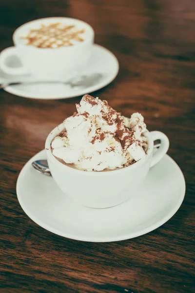 stock image Hot marshmallow chocolate in white cup on table in cafe shop - Vintage Filter