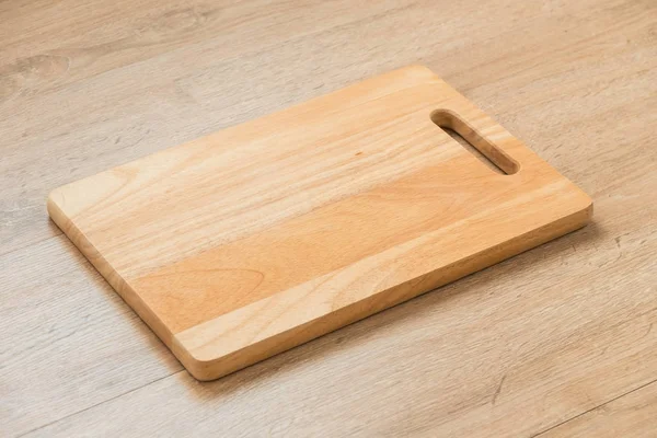 Wood cutting board on wooden background with copy space