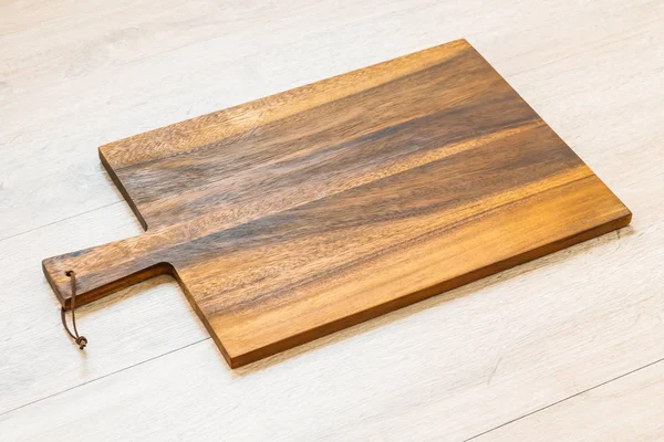 Wood cutting board on wooden background with copy space