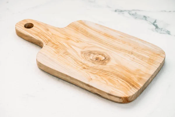 Wood cutting board on white marble stone background