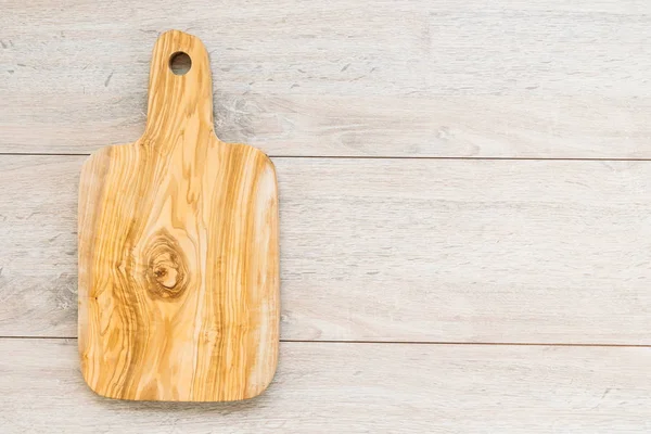 Wood cutting board on wooden background with copy space