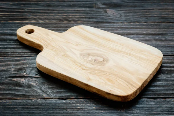 Wood cutting board on wooden background with copy space