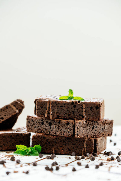 Sweet dessert with chocolate brownies on white stone background