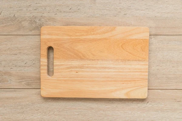 Wood cutting board on wooden background with copy space