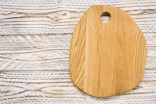 Wood cutting board on wooden background with copy space