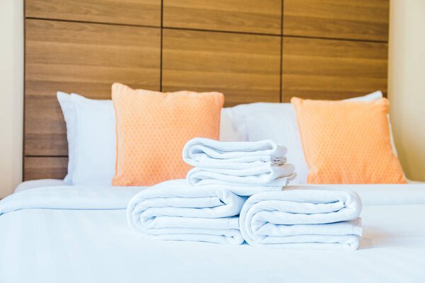 White bath towel on bed