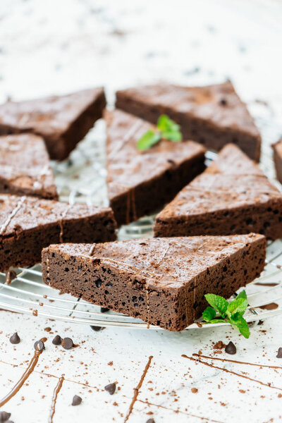 Sweet dessert with chocolate brownies on white stone background