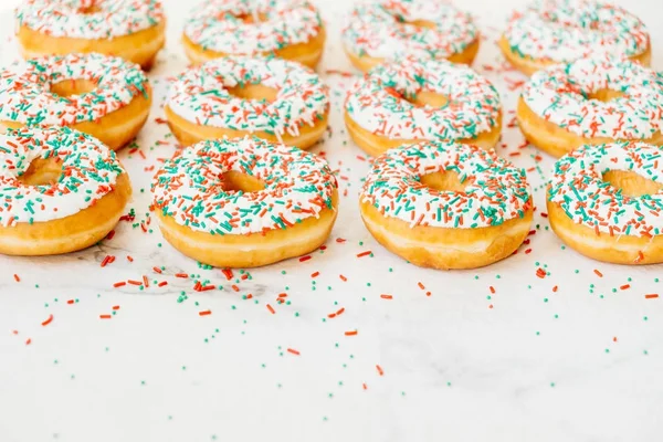 Donuts with white chocolate cream and sprinkles sugar — Stock Photo, Image