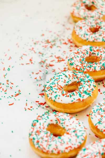 Donuts with white chocolate cream and sprinkles sugar on top - Unhealthy food style