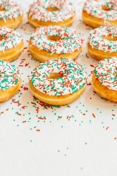 Donuts with white chocolate cream and sprinkles sugar on top - Unhealthy food style