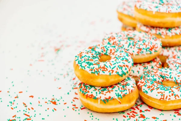 Donuts with white chocolate cream and sprinkles sugar on top - Unhealthy food style