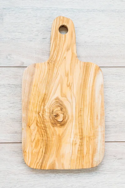 Wood cutting board on wooden background with copy space