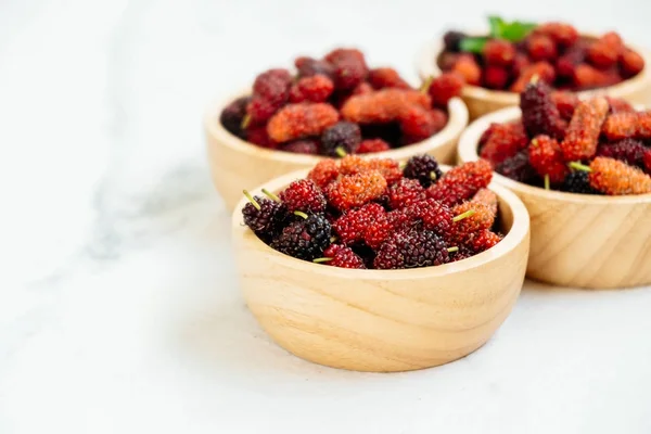 Red and Black mulberry fruit in bowl on white stone background — Stock Image Red Black Mulberry Fruit Bowl White Stone Background Royalty Free Stock Images