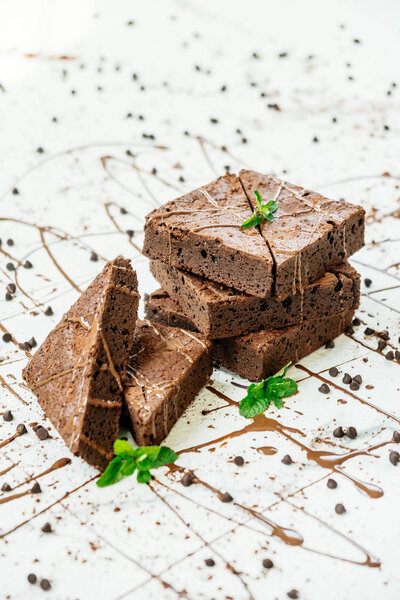 Sweet dessert with chocolate brownies on white stone background