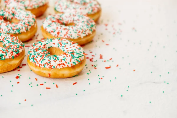 Donuts with white chocolate cream and sprinkles sugar on top - Unhealthy food style