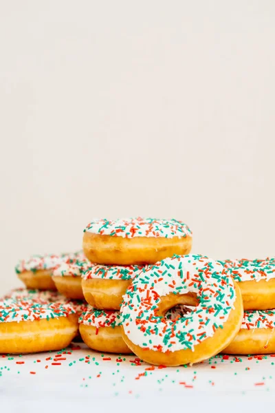 Donuts with white chocolate cream and sprinkles sugar on top - Unhealthy food style