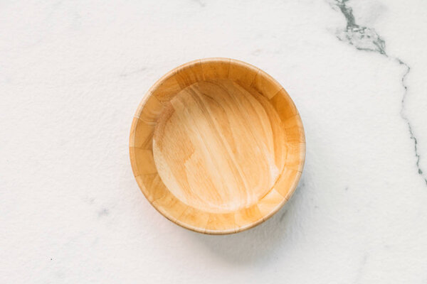 Wood bowl on white marble stone background