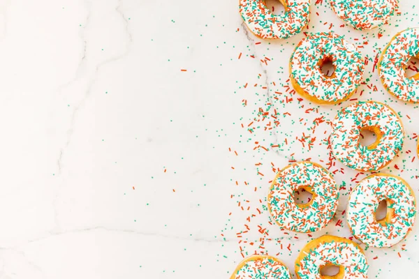 Donuts with white chocolate cream and sprinkles sugar on top - Unhealthy food style