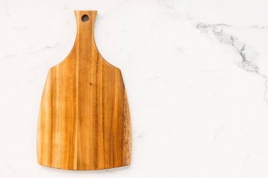 Ahşap kesme tahtası beyaz mermer taş zemin üzerine