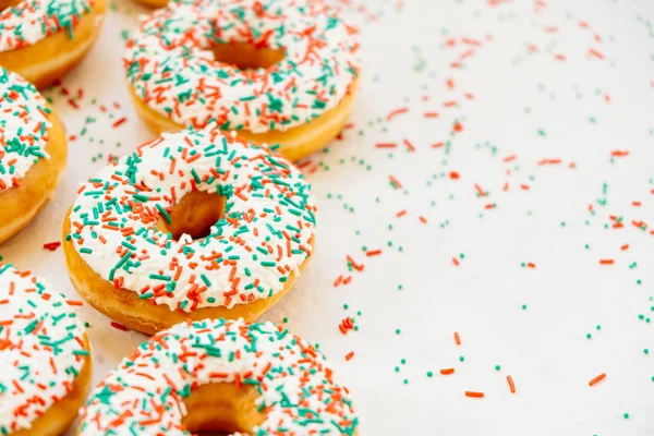 Donuts with white chocolate cream and sprinkles sugar — Stock Photo, Image