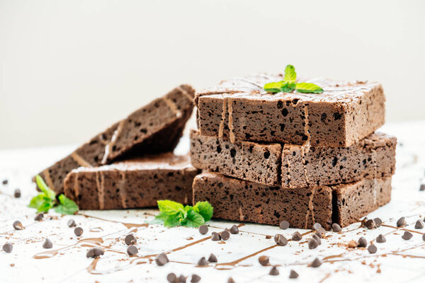 Sweet dessert with chocolate brownies on white stone background