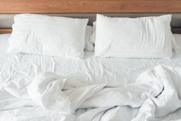 White pillow with rumpled bed — Stock Photo, Image