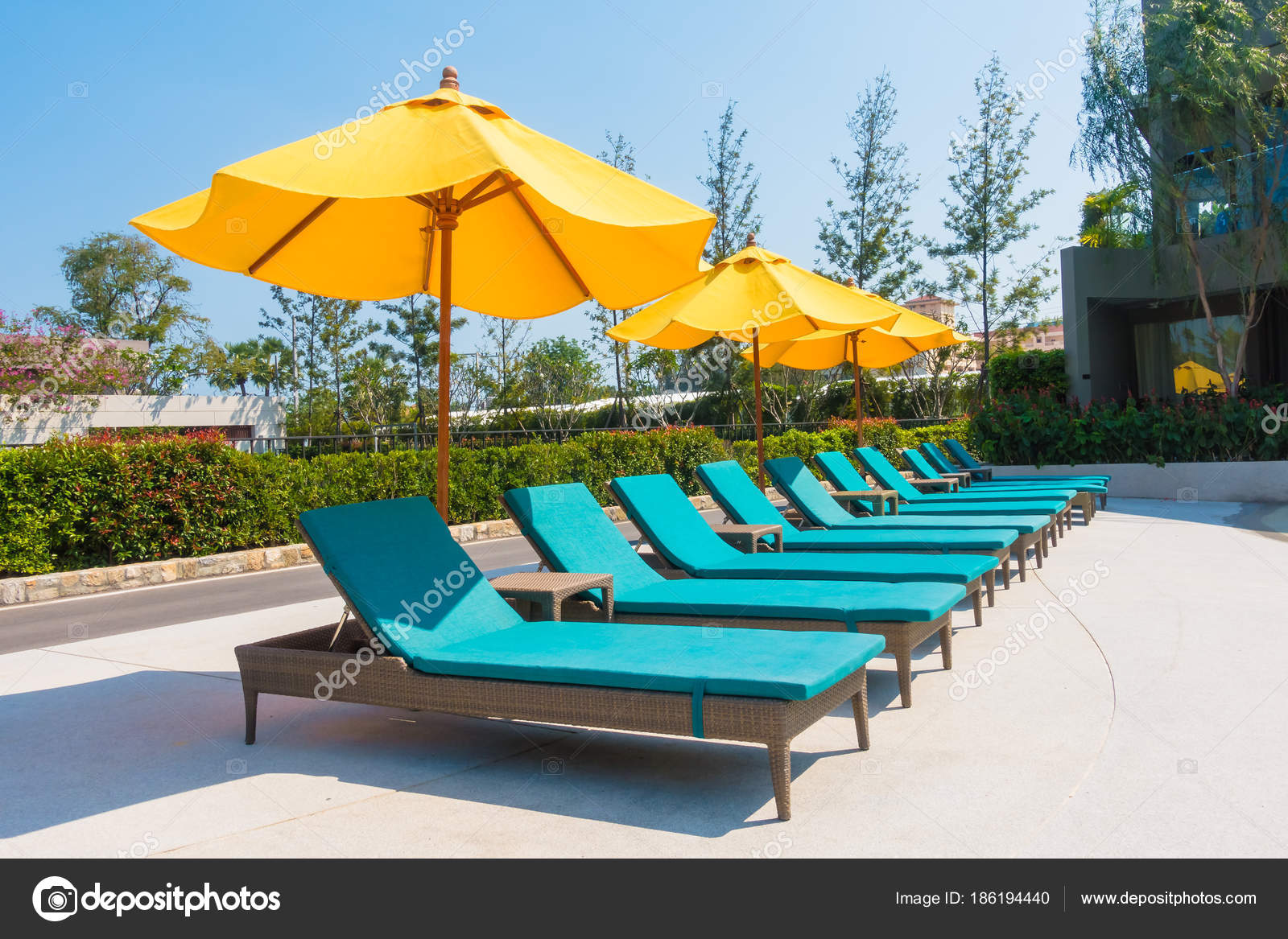 Umbrella And Chair Around Swimming Pool Stock Photo