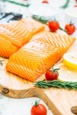 Ahşap kesme tahtası üzerinde ham ve taze somon eti fileto