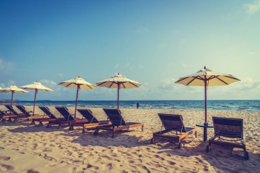 Şemsiye ve sandalye üzerinde plaj ve deniz